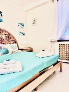 a bedroom with a large bed with a blue mattress at Villa Liuba in Ischia