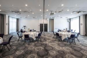 a conference room with tables and chairs and a podium at Scandic Sluseholmen in Copenhagen