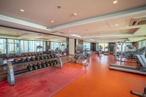 a gym with a lot of exercise equipment in a building at Radisson Blu Pune Hinjawadi in Pune