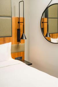 a bedroom with a bed and a mirror at Radisson Blu Hotel, Hamburg Airport in Hamburg