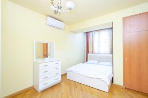 a bedroom with a bed and a dresser and a mirror at Amiryan15/7 Excellent apartment in the center in Yerevan