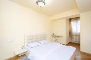 a bedroom with a large white bed in a room at Amiryan15/7 Excellent apartment in the center in Yerevan