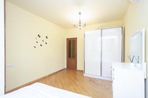 a white room with a bed and a mirror at Amiryan15/7 Excellent apartment in the center in Yerevan +6 photos