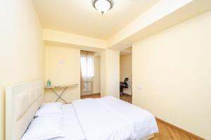 a bedroom with a white bed and a desk at Amiryan15/7 Excellent apartment in the center in Yerevan