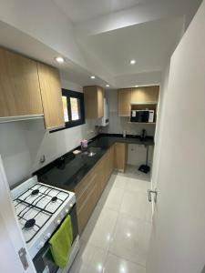 a kitchen with a stove and a stove top oven at Dalcar Apart in Río Cuarto