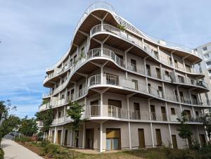 an apartment building with a spiral staircase on it at Appartement Confort in Vélizy-Villacoublay