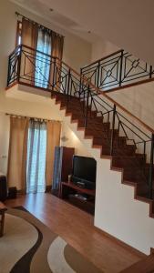 a living room with a staircase and a television at Maria Vagueira BeachHouse in Vagos