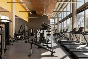 a gym with rows of exercise bikes and treadmills at Sonder at East 5th in Austin