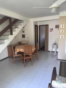 CamassariにあるVilage 3/4 aconchegante em Guarajubaのダイニングルーム(テーブル、椅子、階段付)
