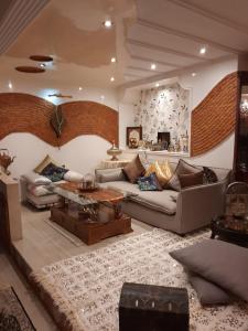 a living room with a couch and a table at Luxury duplex in the centre of Maarif in Casablanca