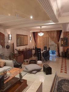 a living room with a couch and a table at Luxury duplex in the centre of Maarif in Casablanca