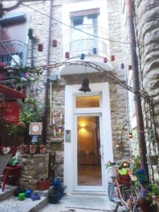 a white door in a stone building with plants at Holiday home in Caccamo - Sizilien 49210 in Caccamo