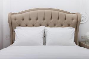 a bedroom with a bed with white pillows at Elysian Haven in Athens