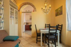 una sala da pranzo con tavolo e sedie di Ponte per la Sardegna e la Corsica dalla Toscana family apartment a Livorno