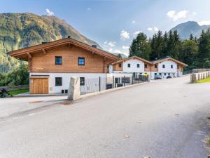 a large building with a mountain in the background at Chalet Degens in Krimml