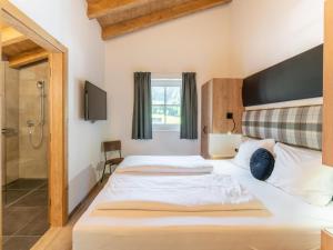 a bedroom with a large bed and a shower at Chalet Degens in Krimml