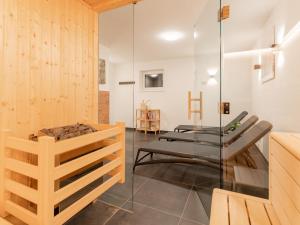 a room with wooden walls and a glass wall at Chalet Degens in Krimml