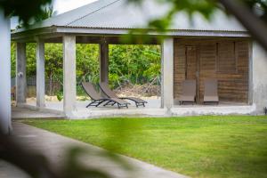 a group of chairs sitting on a pavilion at Villa Lynko - 3 Chambres Climatisées - Jardin Tropical - Plages du Moule à 10 minutes in Le Moule +20 photos