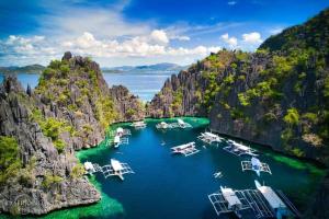 an aerial view of boats in a harbor in a bay at Rovi Homestay in Coron