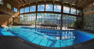 a large swimming pool in a building with a large window at New Denver Lodge in New Denver