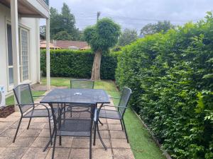 a table and chairs sitting on a patio at Lifestyle Apartments at Ferntree in Fern Tree Gully
