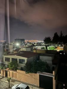 a view of a city at night with buildings at Departamento en José Luis Bustamante y Rivero in La Pampilla