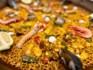 a pizza with different types of food on it at Casita Bonita - with private garden near beach in Jávea in Jávea