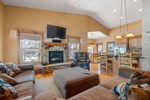 a living room with a couch and a fireplace at New! Black Bear Inn - Pet friendly - trailer parking - walk to lake - rustic in Donnelly