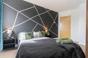 a bedroom with a large black and white wall at City View Free Parking Sleep 6 in Leicester