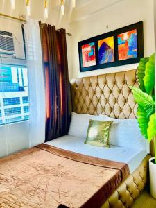 a bed in a room with a large window at Alabang condo near Bellevue Hotel Filinvest City in Manila