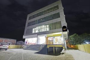 a tall building with stairs in front of it at night at Townhouse OAK Hi-City in Kamakhya