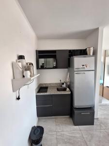 a kitchen with a white refrigerator and a sink at Edificio Charlotte (zona centro) in Posadas