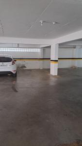 a white car parked in an empty parking lot at Apartamento mobiliado na Capital do Vinho (Bento) in Bento Gonçalves