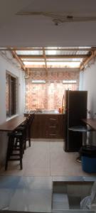 a kitchen with wooden cabinets and tables and a brick wall at K-zona 70 in Medellín