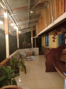 a large room with a porch with a table and chairs at Casitas del Río Bijagua in Bijagua