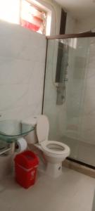 a bathroom with a toilet and a glass shower at K-zona 70 in Medellín