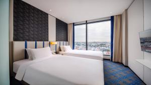 Holiday Inn Express Singapore Katong by IHG客房内的一张或多张床位