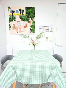 une table verte et blanche avec un vase de fleurs sur elle dans l'établissement [New]Seongsu/Konkuk U/PoguniStay, à Séoul