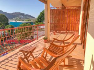 a balcony with two chairs and a table on it at Grand Plaza in San Juan del Sur