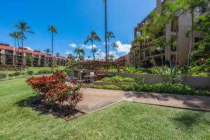a park at the resort with palm trees and plants at Kamaole Sands 7307 in Wailea