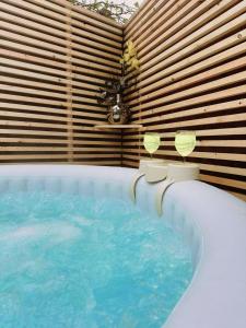 a jacuzzi tub with two glasses in a room at 1 Bedroom apartment With Hot Tub in cardiff in Cardiff