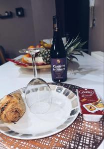 a table with a plate of food and a bottle of wine at 1 Bedroom apartment With Hot Tub in cardiff in Cardiff