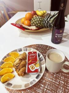 a plate of food with a cup of coffee and a plate of fruit at 1 Bedroom apartment With Hot Tub in cardiff in Cardiff