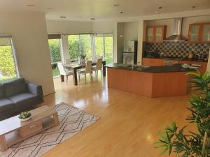 a kitchen and living room with a couch and a table at House on the Heights in Lyndhurst