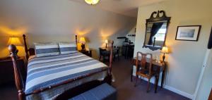 a bedroom with a bed and a mirror and a table at Amherst Shore Country Inn in Lorneville