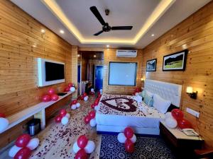 a room with a bed with red and white balloons at Hotel Wood Stock Luxury - A Boutique Property - Penthouse - Open Air Restaurant & Terrace in Kasauli