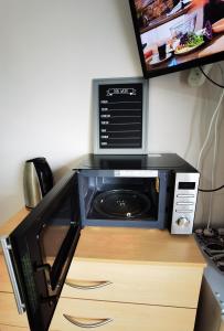 a microwave oven sitting on top of a cabinet at Toro's place in Sedgley