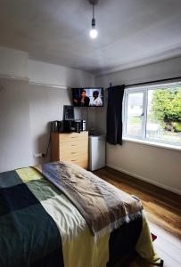 a bedroom with a bed and a window at Toro's place in Sedgley