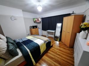 Schlafzimmer mit einem Bett, einem Schreibtisch und einem Schrank in der Unterkunft Toro's place in Sedgley