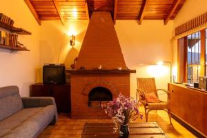 a living room with a brick fireplace and a couch at Cabaña duplex el Sosiego. in El Tigre